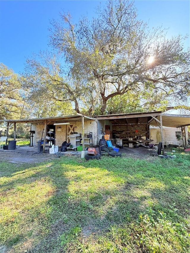 back of property featuring an outbuilding