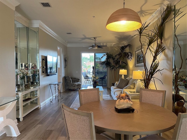 dining area with hardwood / wood-style floors, ceiling fan, and crown molding