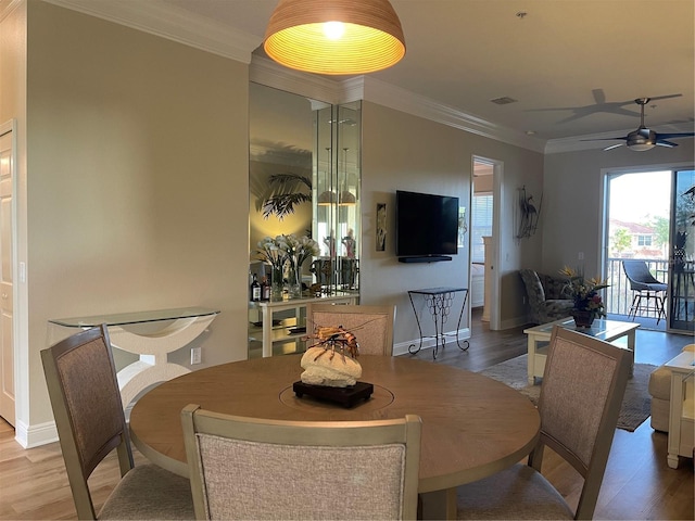 dining area featuring ceiling fan, ornamental molding, and light hardwood / wood-style flooring