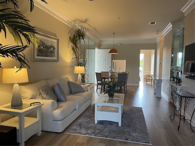 living room with hardwood / wood-style floors and ornamental molding