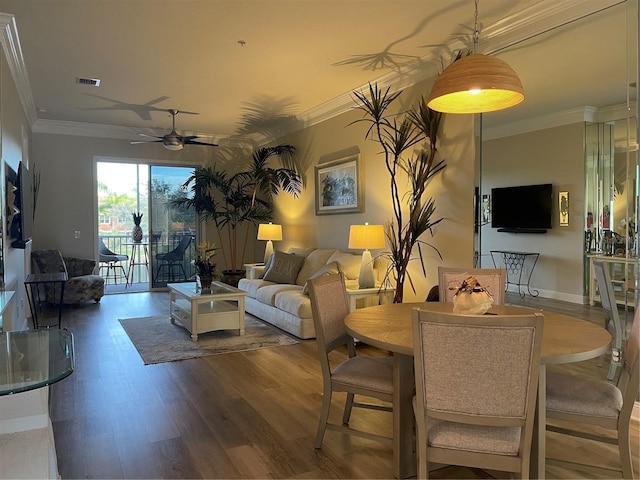 living room with ceiling fan, dark hardwood / wood-style flooring, and ornamental molding