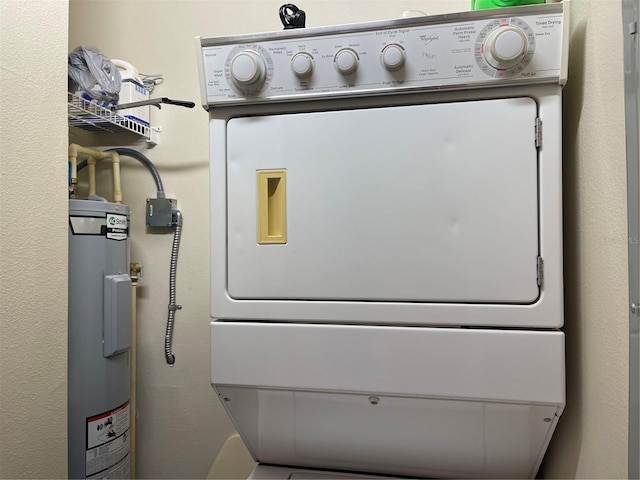 laundry area with electric water heater and stacked washer / drying machine