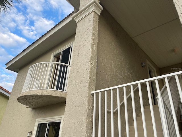 view of side of home with a balcony