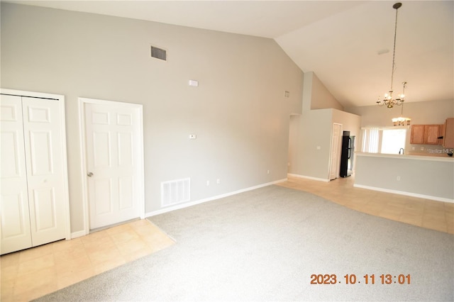 unfurnished living room featuring light tile patterned floors, high vaulted ceiling, and an inviting chandelier