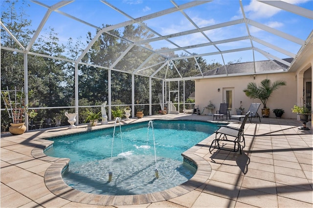 view of swimming pool with pool water feature, glass enclosure, and a patio area