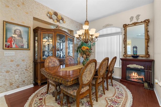 dining space featuring dark hardwood / wood-style floors and a chandelier