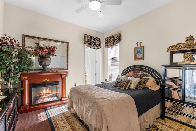 bedroom featuring ceiling fan and dark wood-type flooring