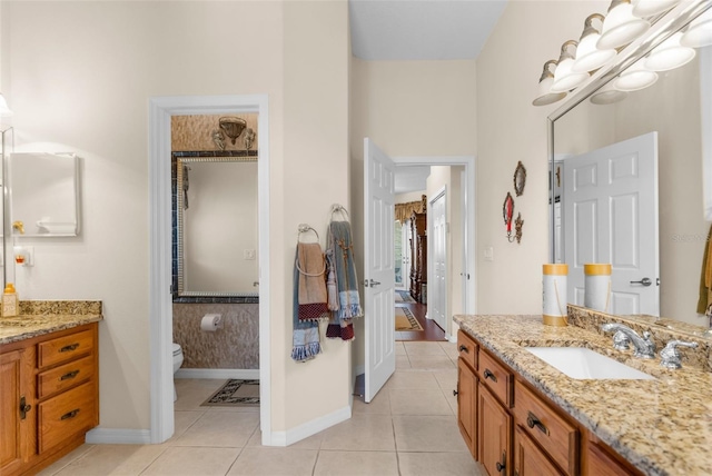 bathroom featuring tile patterned flooring, vanity, and toilet