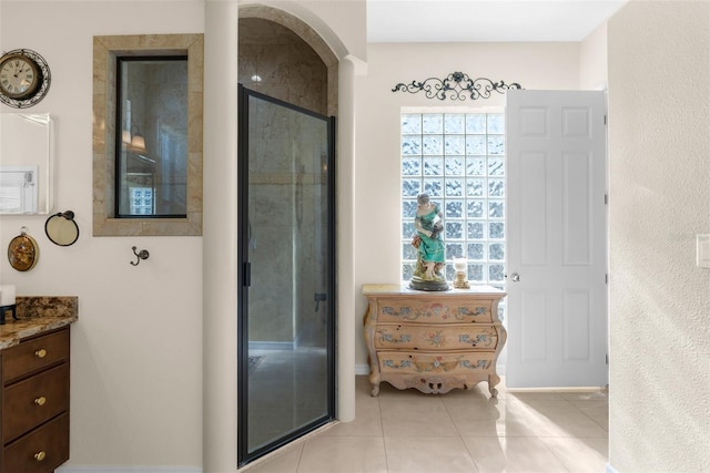 bathroom with vanity, tile patterned floors, and walk in shower