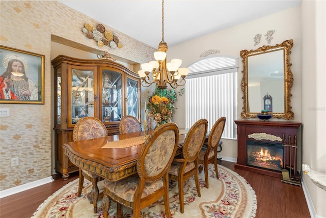 dining room featuring dark wood-type flooring and an inviting chandelier