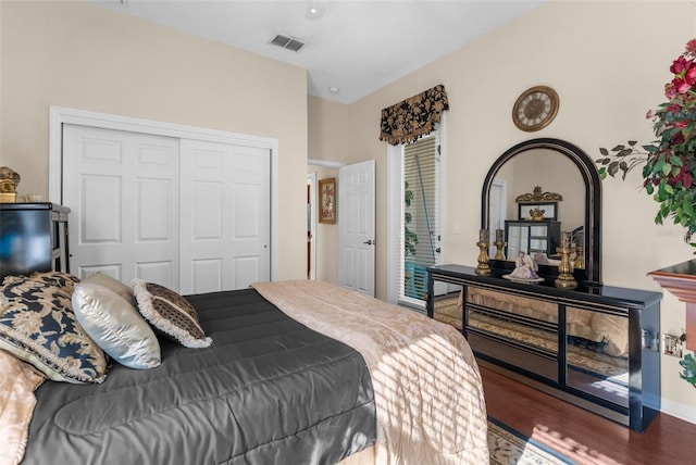 bedroom featuring dark hardwood / wood-style floors and a closet