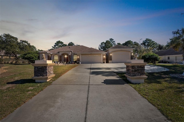 view of front of home with a yard and a garage