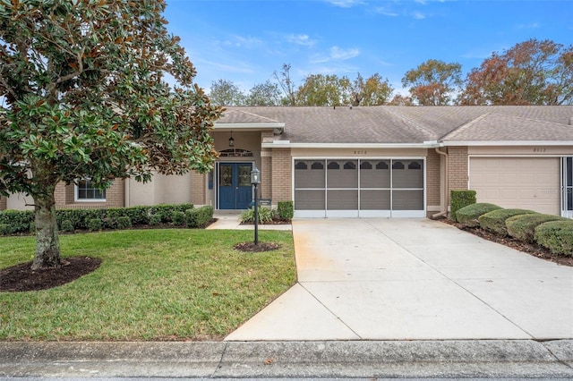 ranch-style house with a front yard and a garage