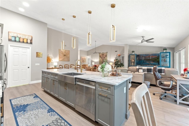 kitchen featuring dishwasher, sink, hanging light fixtures, gray cabinets, and a kitchen island with sink