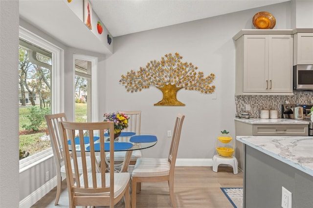 dining area featuring plenty of natural light and light wood-type flooring