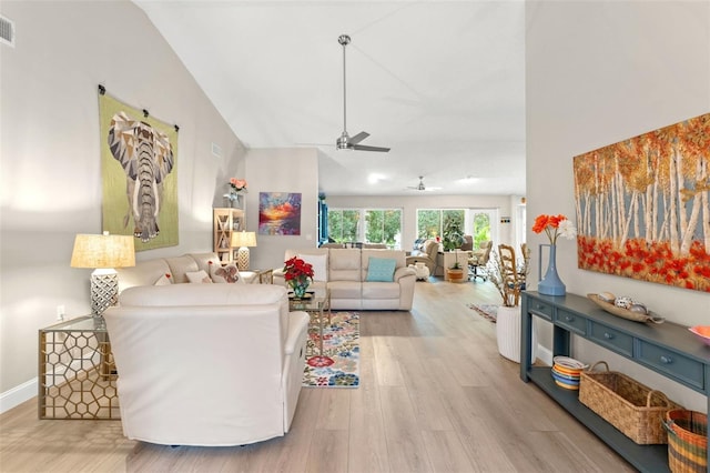 living room with ceiling fan, light wood-type flooring, and vaulted ceiling