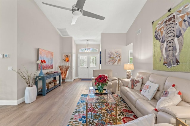 living room with ceiling fan, light hardwood / wood-style flooring, and french doors