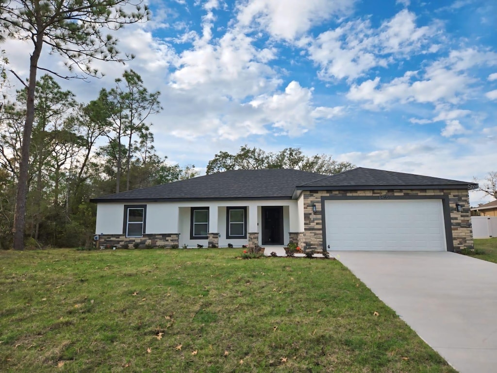 view of front facade featuring a garage and a front lawn