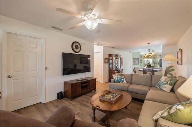 living room featuring ceiling fan and light hardwood / wood-style flooring