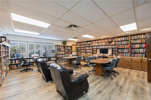 office featuring a paneled ceiling and light wood-type flooring