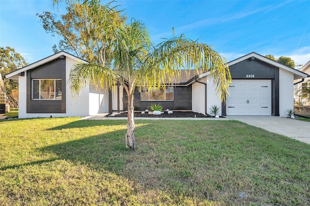 ranch-style house featuring a front yard and a garage