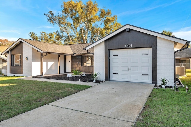 ranch-style home with a front lawn and a garage