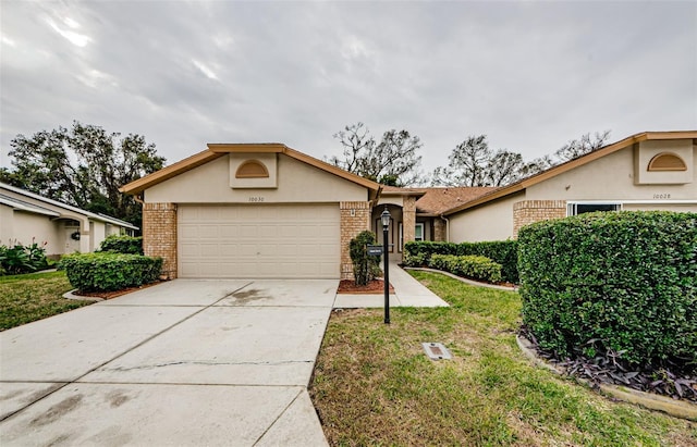 ranch-style house with a garage and a front lawn