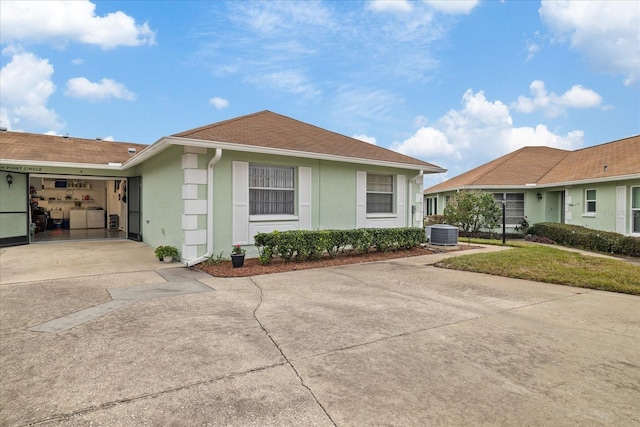 ranch-style house featuring central AC unit and a front lawn