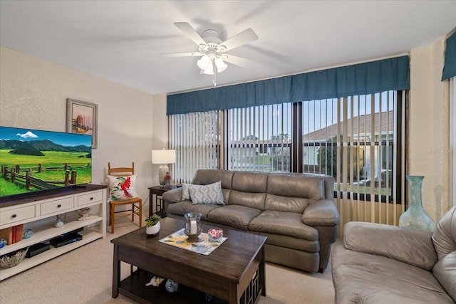 carpeted living room featuring ceiling fan