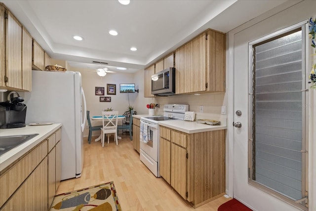 kitchen featuring white appliances, light hardwood / wood-style flooring, light brown cabinetry, tasteful backsplash, and ceiling fan