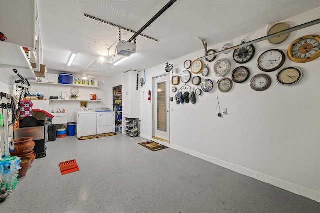 garage with a garage door opener and separate washer and dryer