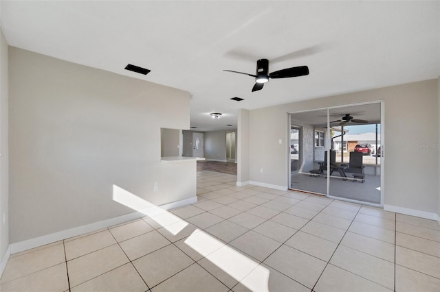 spare room with ceiling fan and light tile patterned flooring