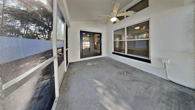 unfurnished sunroom featuring ceiling fan and vaulted ceiling