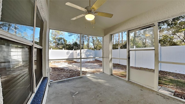 unfurnished sunroom with ceiling fan and a healthy amount of sunlight