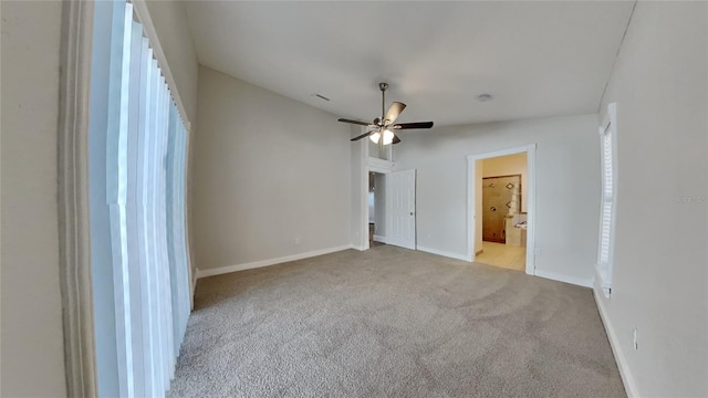 unfurnished bedroom with ensuite bathroom, ceiling fan, light carpet, and lofted ceiling