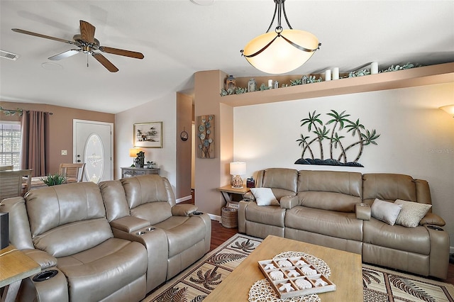 living room with hardwood / wood-style flooring, ceiling fan, and lofted ceiling