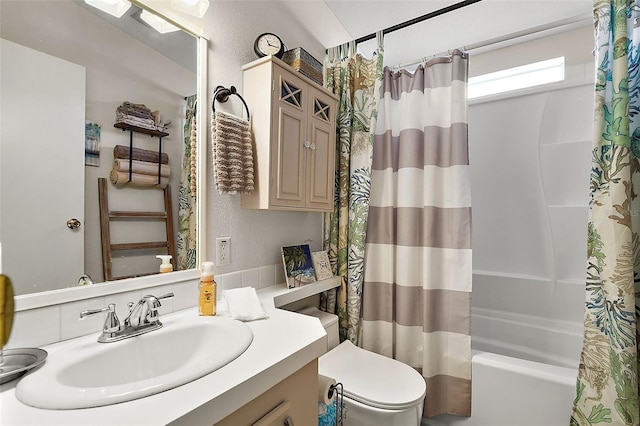 full bathroom with vanity, shower / tub combo, and toilet