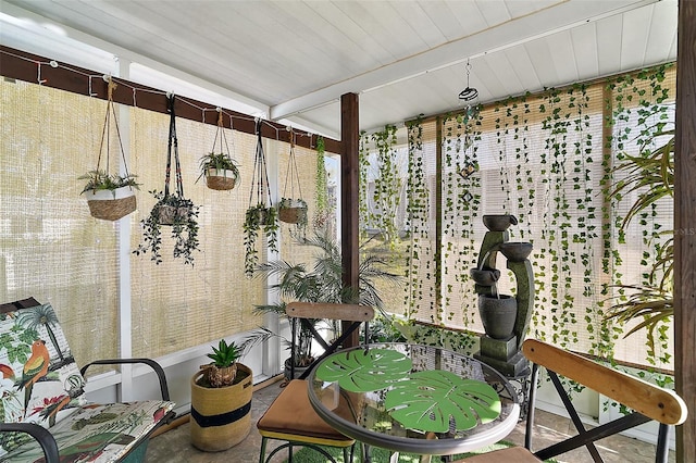 sunroom featuring beamed ceiling