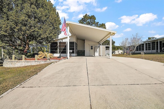 view of front of house with a carport and a front yard