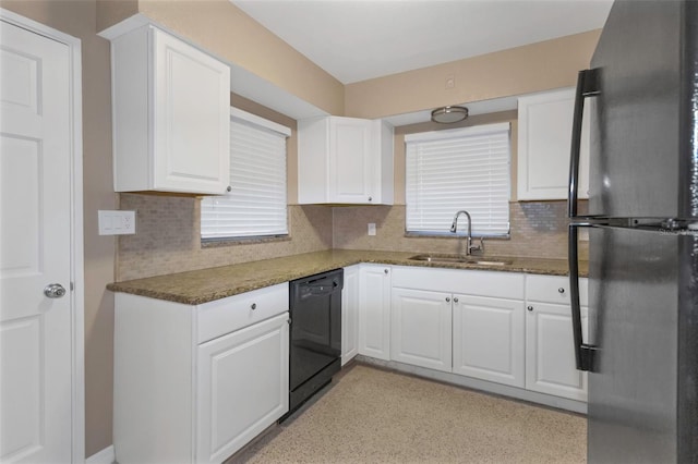 kitchen featuring white cabinetry, sink, black dishwasher, tasteful backsplash, and refrigerator