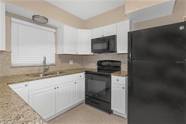 kitchen with light stone countertops, sink, white cabinets, and black appliances