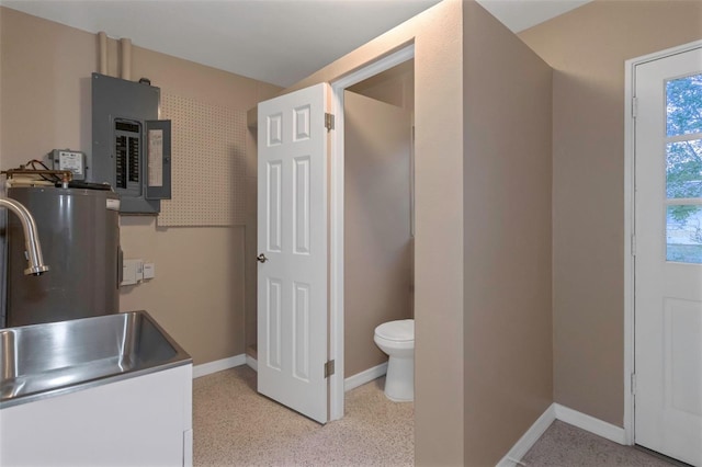 bathroom featuring gas water heater, sink, and electric panel