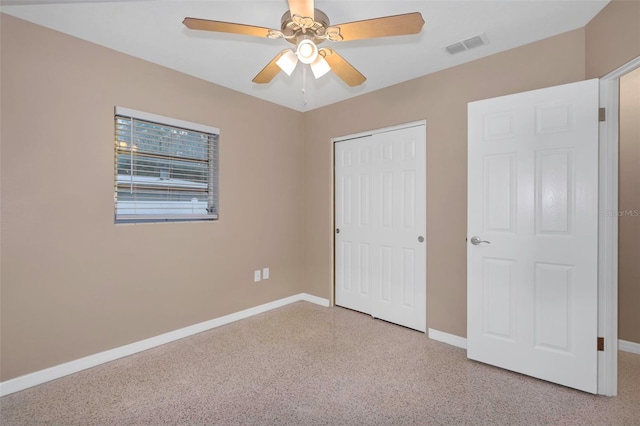 unfurnished bedroom featuring ceiling fan and a closet