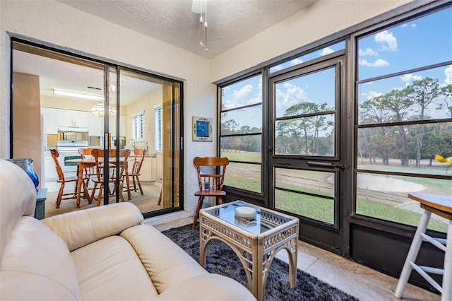 sunroom / solarium with ceiling fan