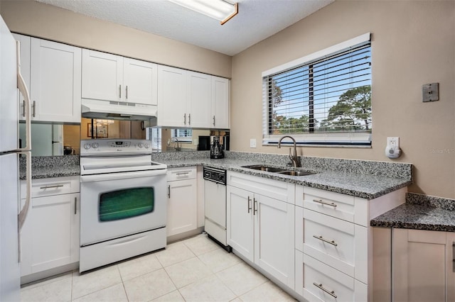 kitchen with white appliances, sink, stone counters, white cabinetry, and light tile patterned flooring