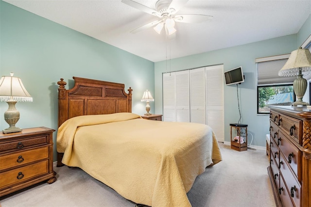 carpeted bedroom with a closet and ceiling fan