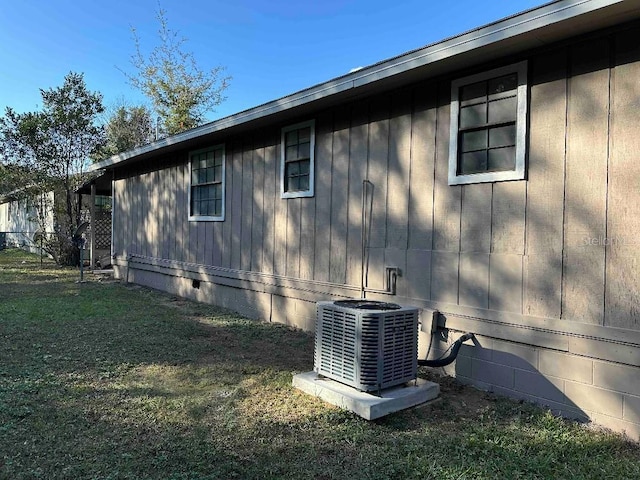 view of home's exterior featuring a yard and central AC unit