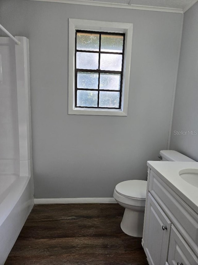 full bathroom with vanity, hardwood / wood-style flooring, toilet, and shower / washtub combination