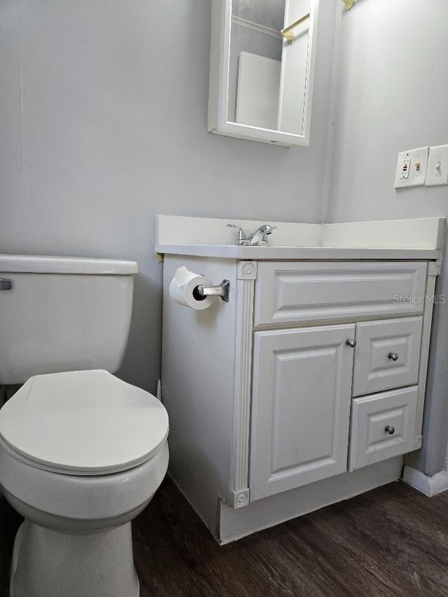 bathroom featuring wood-type flooring and toilet