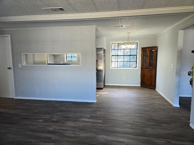 interior space featuring an inviting chandelier, dark hardwood / wood-style floors, and ornamental molding